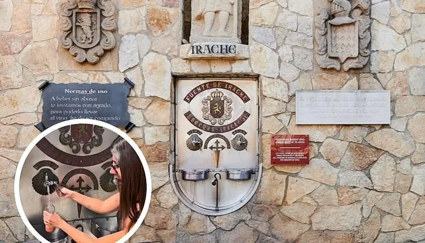 Fuente de vino en el Camino de Santiago. Una mujer llena una botella en la Fuente de Irache, que ofrece vino gratis a los peregrinos.
