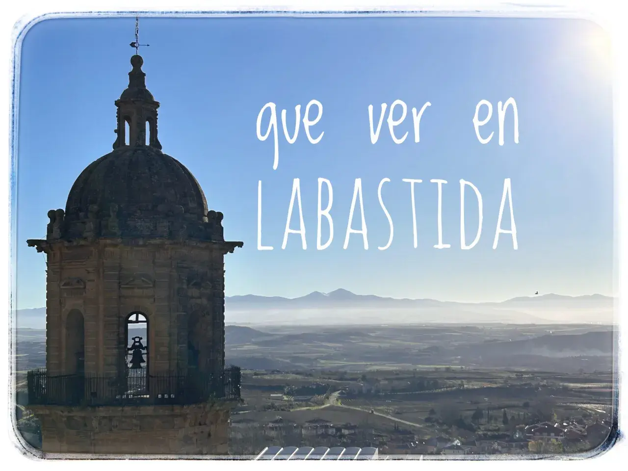 Torre con campana y paisaje montañoso. Descubre qué ver en Labastida y cómo llegar a este pintoresco pueblo.