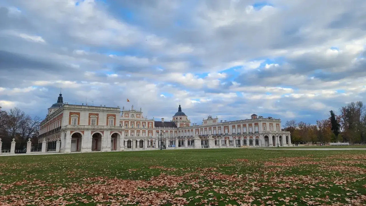 Palacio Real de Aranjuez, un destino ideal para visitar. El césped cubierto de hojas y el cielo nublado anuncian la llegada del otoño.